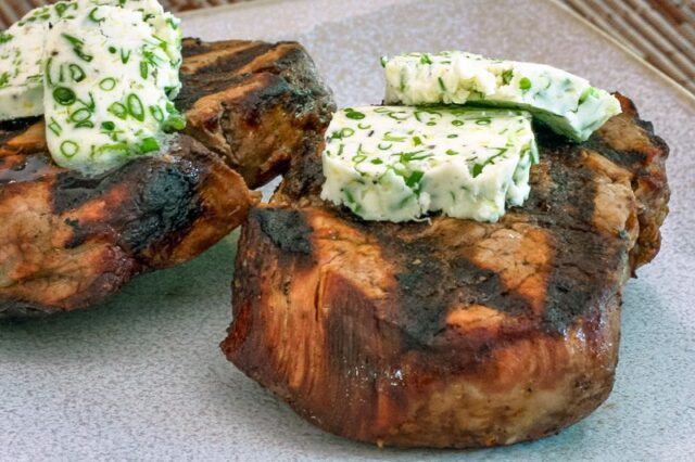 herb butter on grilled beef steaks