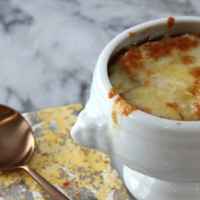 basic french onion soup in a bowl with melted cheese on top