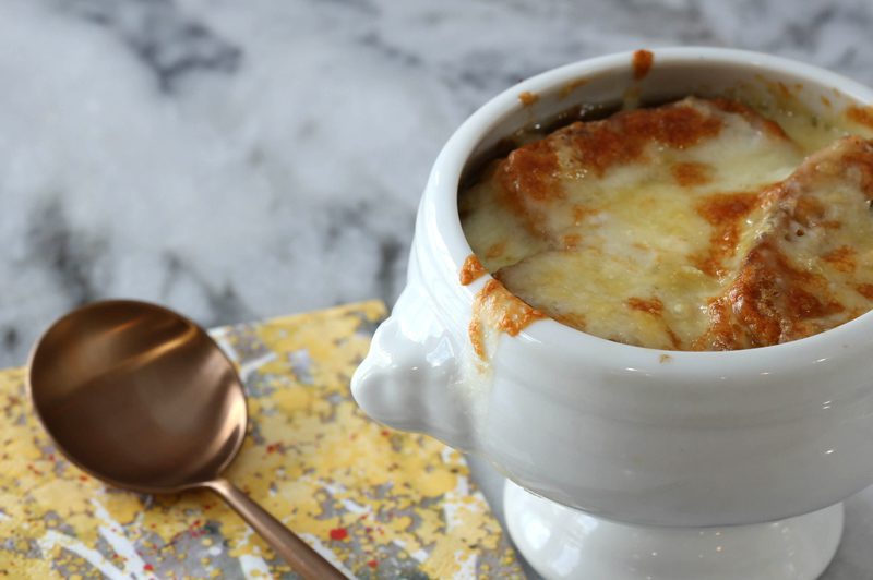 basic french onion soup in a bowl with melted cheese on top
