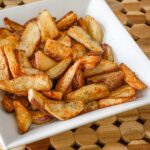 serving dish with roasted potato wedges