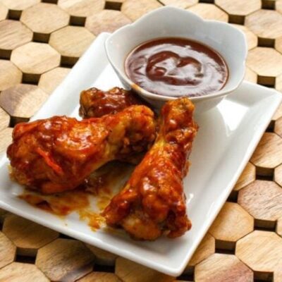 bbq drumettes on a plate with dip