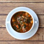 bean and sausage soup in a bowl