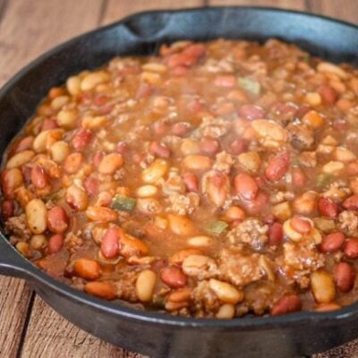 cookout beans with beef in a large iron skillet