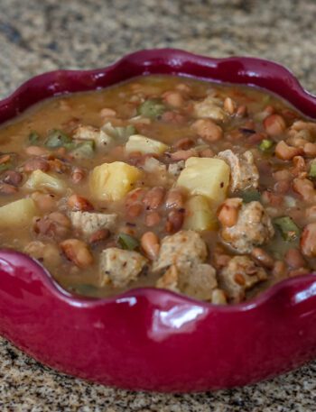 slow cooker pineapple beans with sausage in a serving dish