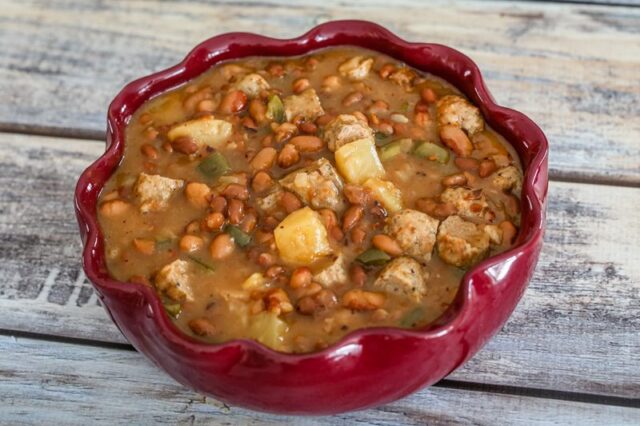 Slow cooker pineapple beans with sausage in a serving bowl