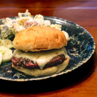 Juicy cheeseburger with melted cheese on a soft bun.