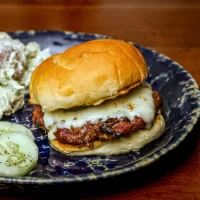 Crispy cheeseburger with melted cheese in a soft bun.