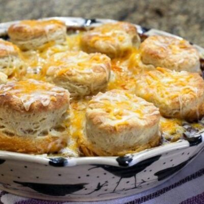 beef and bean casserole with biscuits and cheese topping