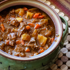 Stew with beef, potatoes, and carrots in a brown gravy.