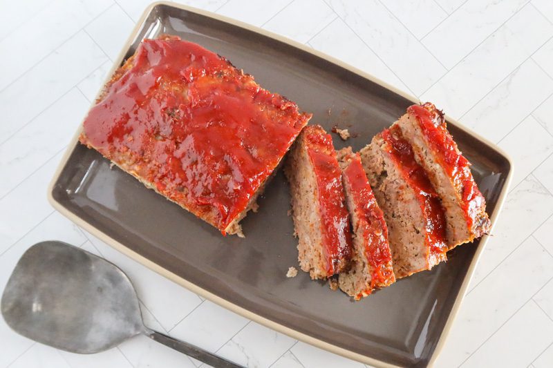 overhead photo of the beef and pork meatloaf with several slices cut out