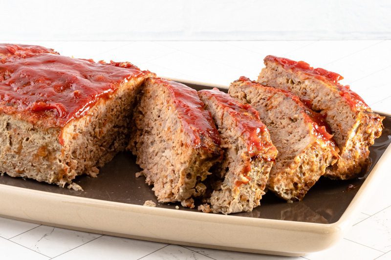 Sliced beef and pork meatloaf on a tray