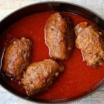 beef rolls, rouladen, and tomato sauce in a dutch oven