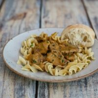 beef steak stroganoff and noodles on a plate