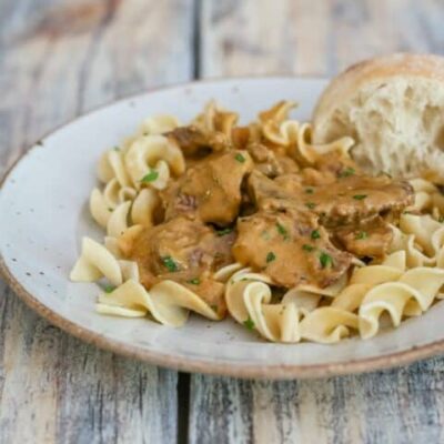 a plate of beef stroganoff on noodles