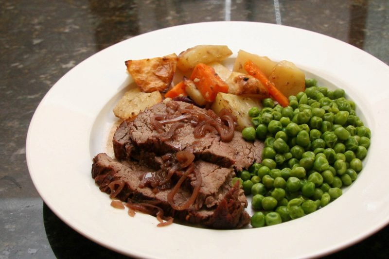 sliced beef tenderloin roast with carrots, potatoes, and onions