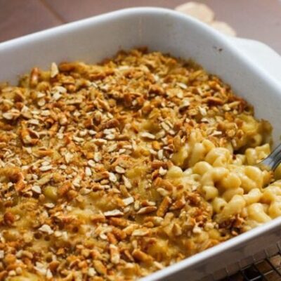 beer macaroni and cheese with a pretzel topping, in a baking dish