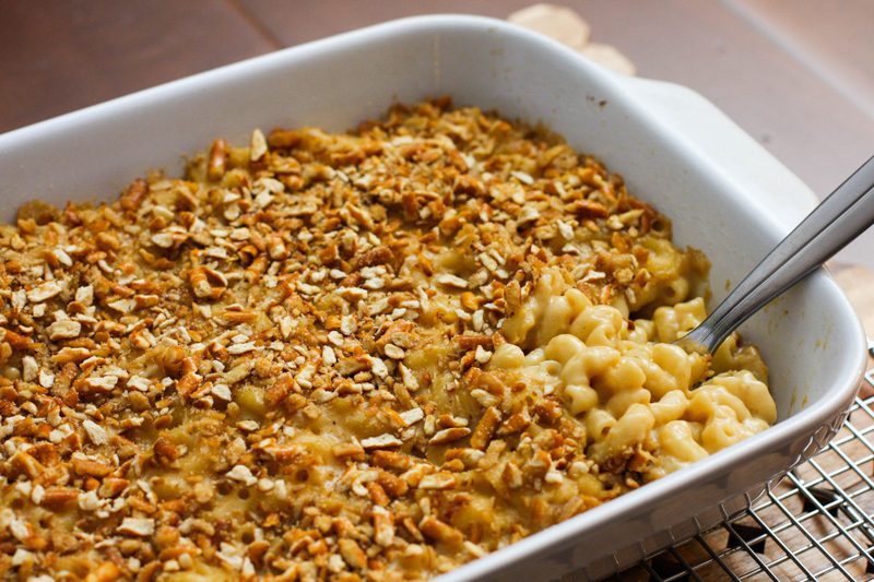 beer macaroni and cheese with a pretzel topping, in a baking dish
