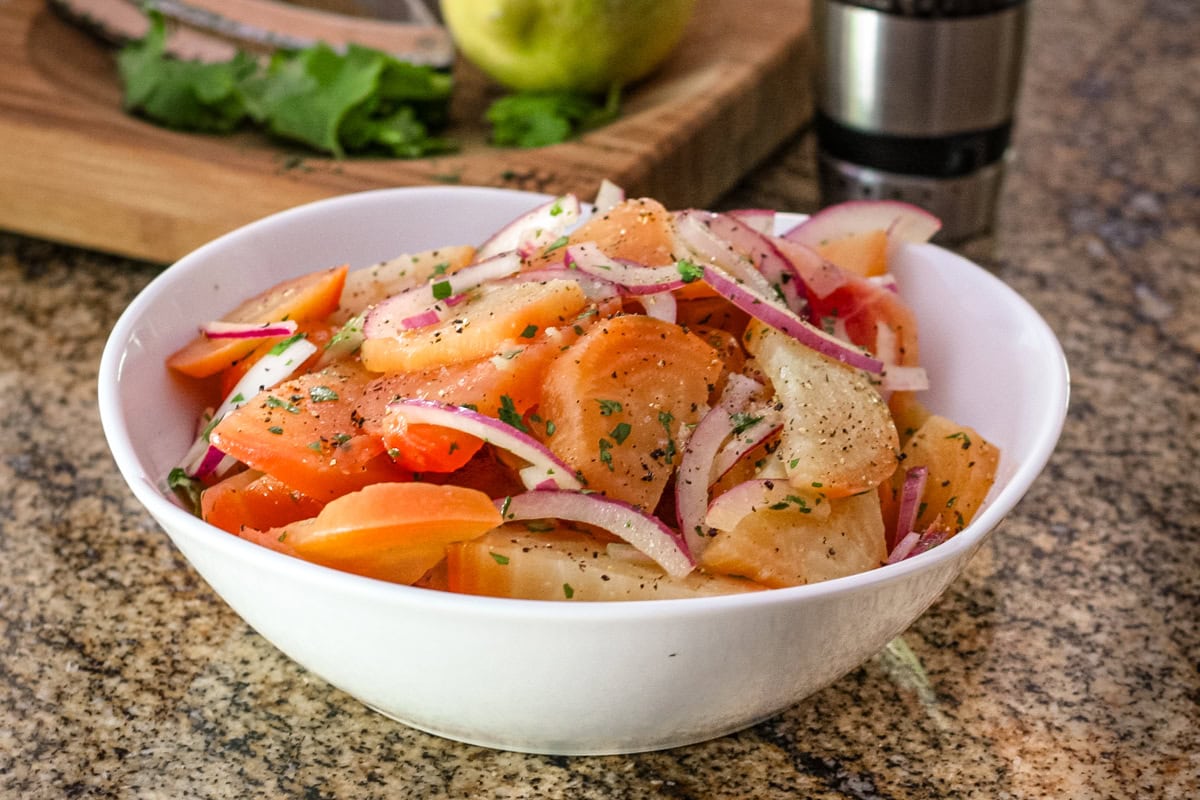 A beet salad with golden beets, red onions, and a lemon vinaigrette.