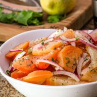 Beet salad with vinaigrette and red onions, in a serving bowl.