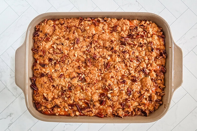 Baked sweet potato casserole with pecan and brown sugar topping.