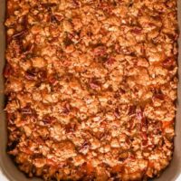 Baked sweet potato casserole in a baking dish with pecan streusel topping.