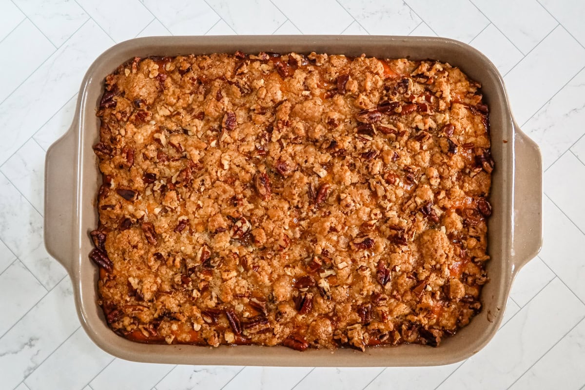 Sweet potato casserole in a baking dish with a brown sugar and pecan topping.