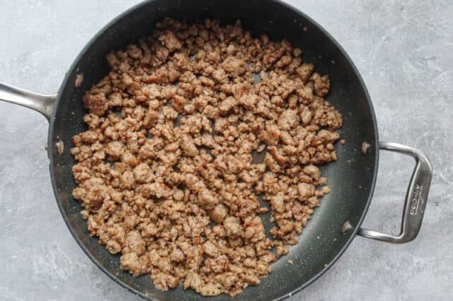 Browned sausage in the skillet.