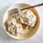 southern biscuits and sausage gravy on a serving plate