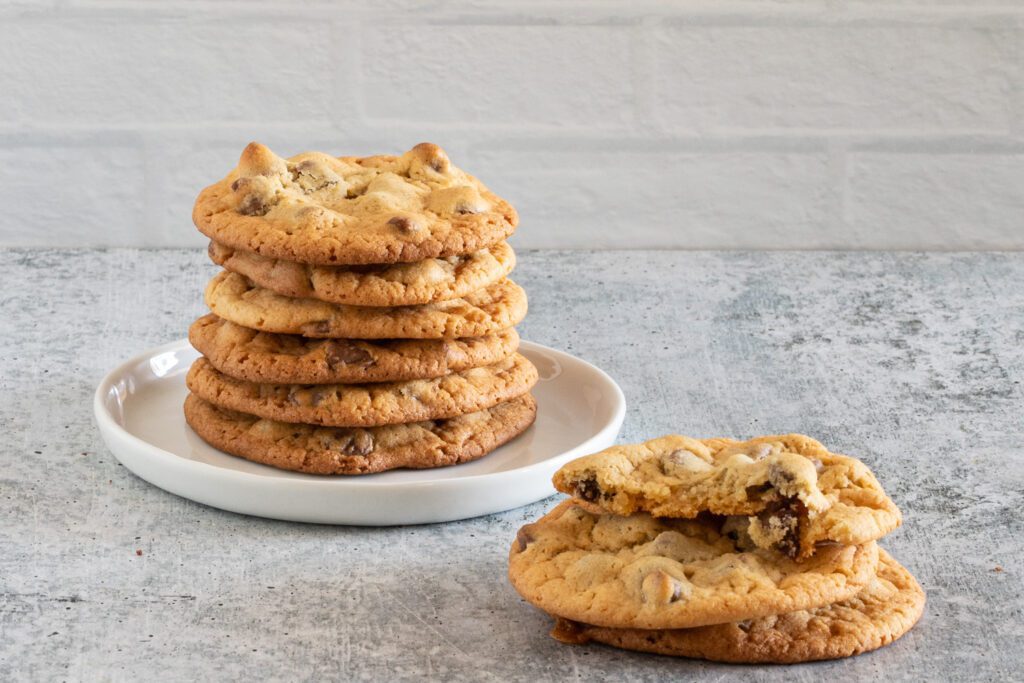 chewy bisquick cookies stacked on a plate with one broken cookie