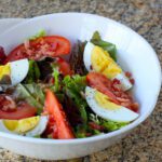 A simple BLT salad in a bowl with mustard vinaigrette.