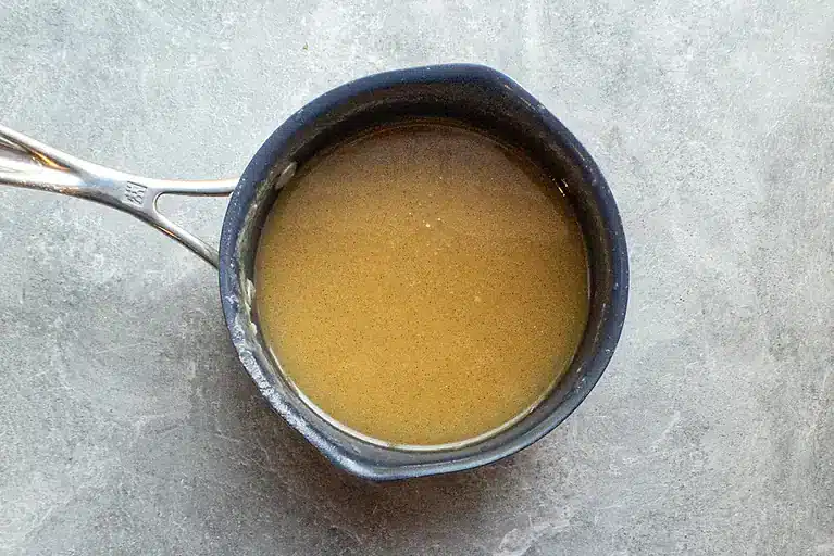Golden broth in a small saucepan.