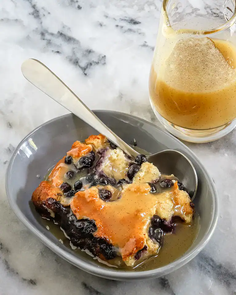Sweet blueberry cobbler with caramel sauce drizzled on top.