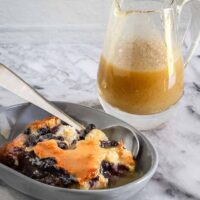 Blueberry bread pudding with golden vanilla sauce.