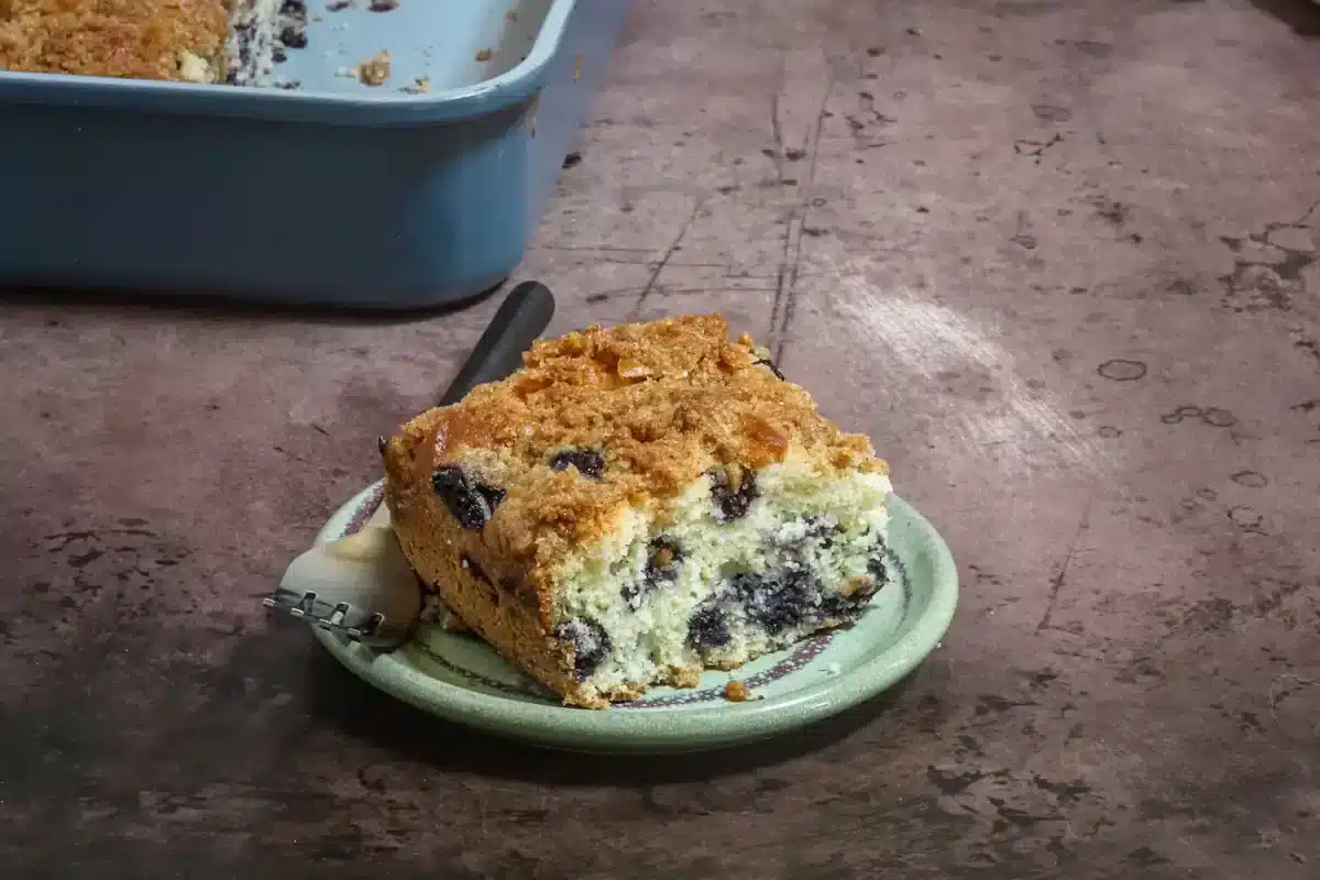 Sweet blueberry crumb cake slice on a small plate.