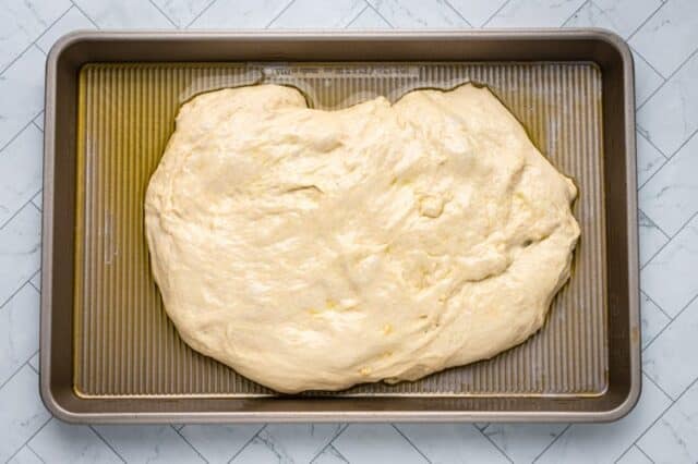 dough in the pan for bread machine focaccia.