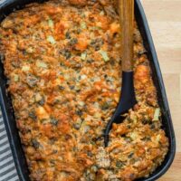 Casserole dish with homemade brioche and sausage stuffing with sage and aromatics.
