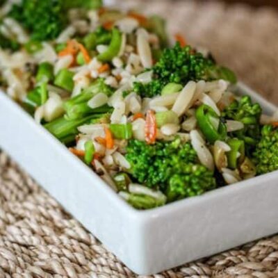 broccoli salad with orzo and wine vinaigrette, in a serving dish.