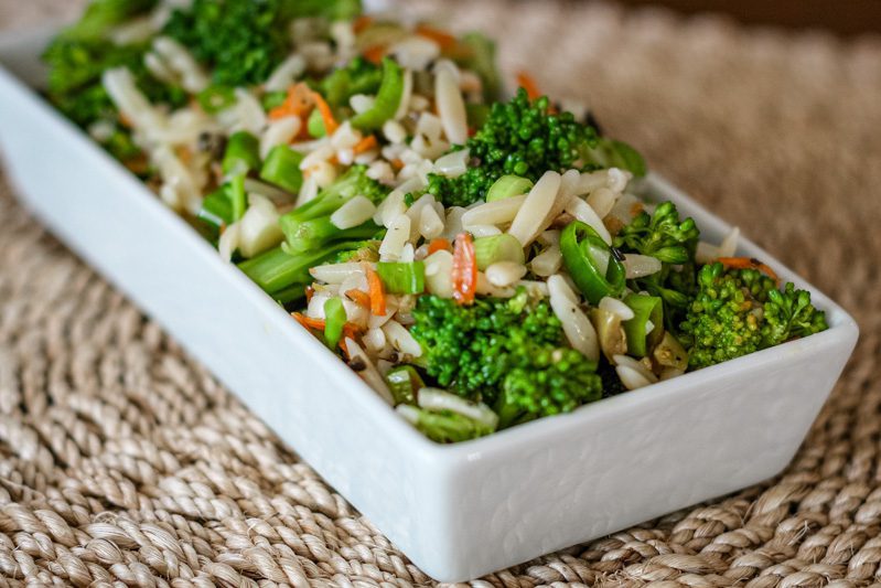 broccoli salad with orzo and wine vinaigrette, in a serving dish.
