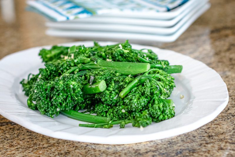cooked broccolini with garlic on a platter
