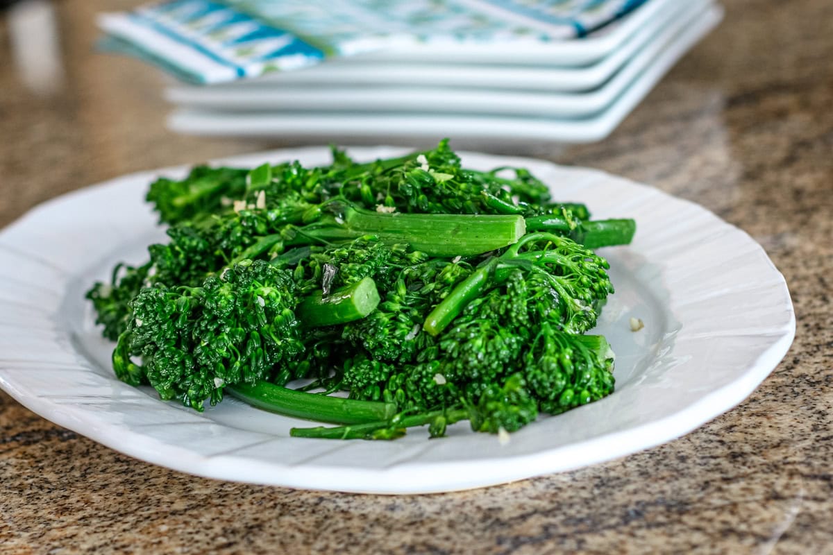 broccolini on a plate, cooked.