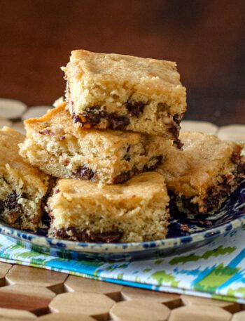 brown sugar bars with chocolate chips, stacked on a plate.