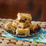 brown sugar bars on a plate, made with chocolate chips and pecans.