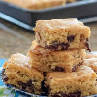 A stack of cake-like brown sugar bars with chocolate chips.