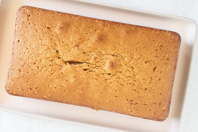 brown sugar pound cake loaf on a tray, ready to slice.