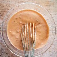 Mixing buffalo mayonnaise spread (or sauce or dip), with a whisk.