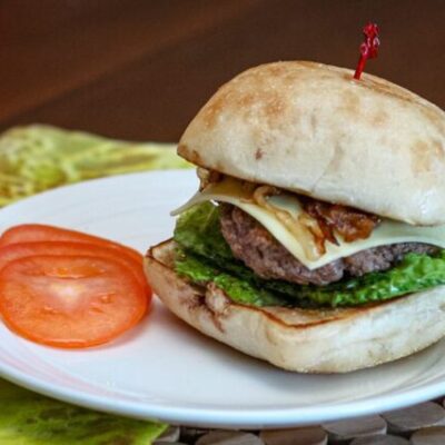 burger with caramelized onions on a ciabatta bun