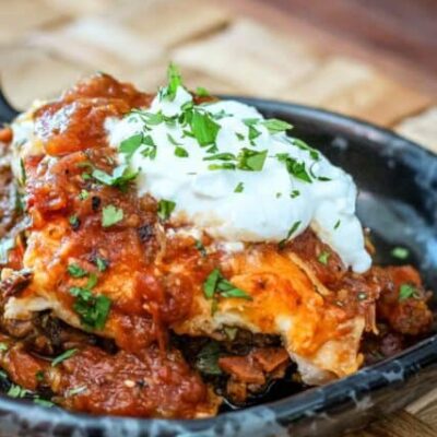 a burrito casserole serving on a pottery plate
