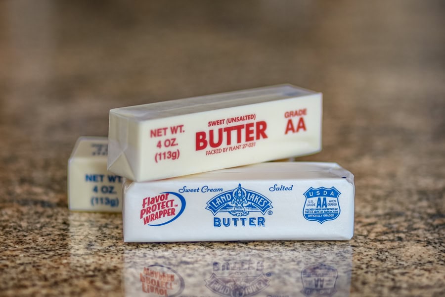 Sticks of butter on the counter, showing unsalted and salted.