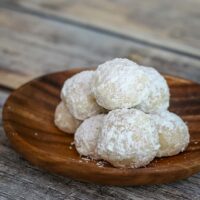 Snowball cookies on a small serving plate.