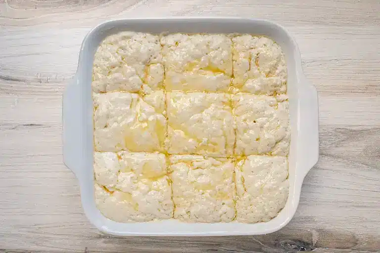 Creamy cottage cheese casserole in a white baking dish.